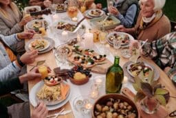 Family celebrating around a large holiday spread.