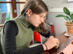 Young girl wearing hearing aids on a video call
