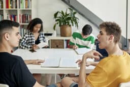 Man with hearing aid talking with his friends