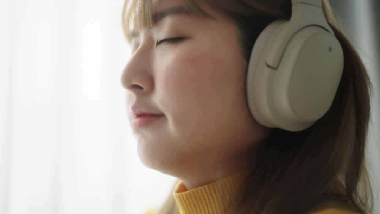 Woman in good mood listens to music