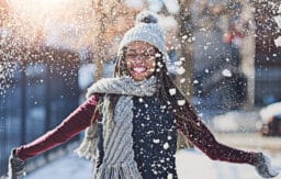 Happy woman showered in snow