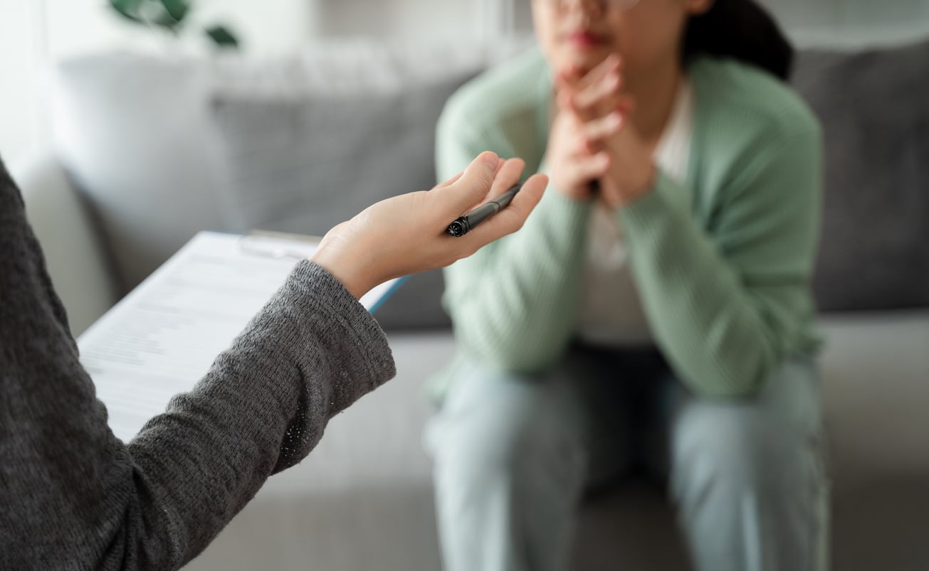 Therapist talking to their patient